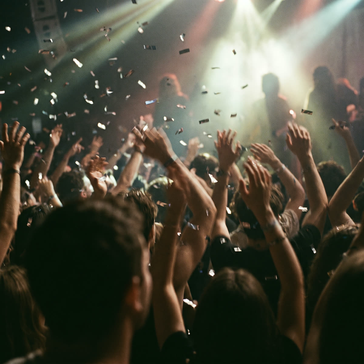 A packed dance floor with confetti at a company dinner and dance