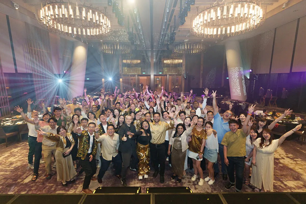 The whole company on the ballroom floor under the chandeliers